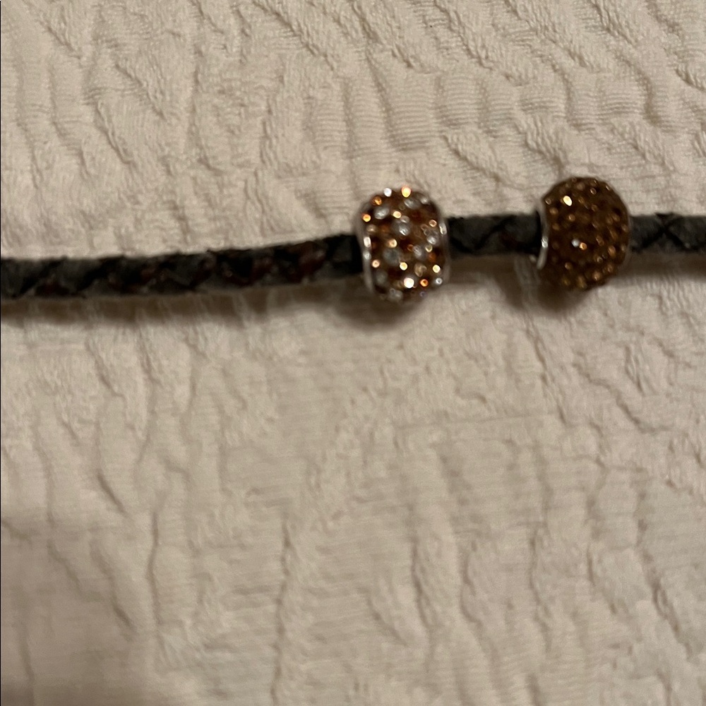 Brown leather band and two Pandora like beads with little sparkly stones